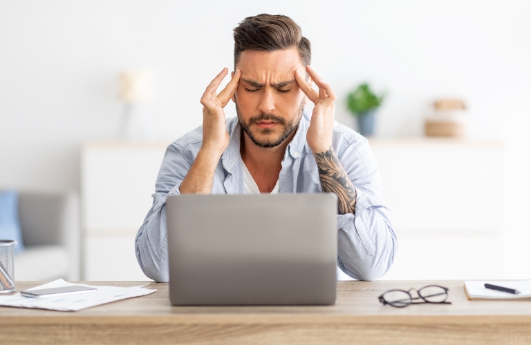 man stressing at a computer